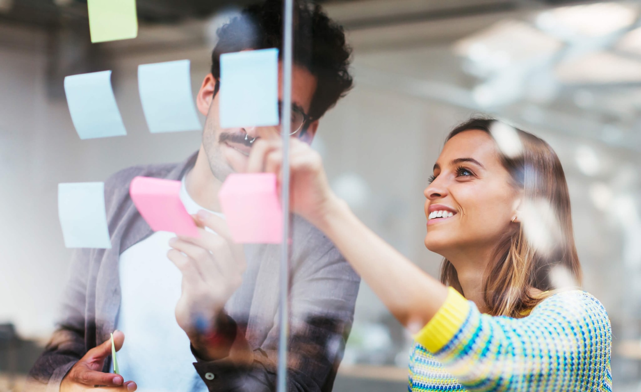 Coworkers brainstorming with postits in office