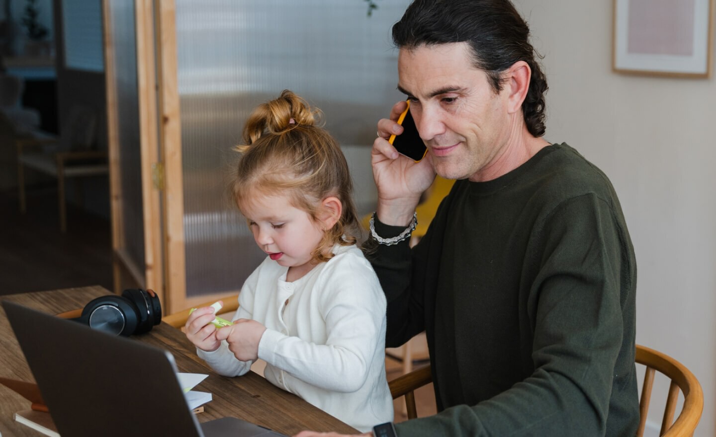 Dad working from home with daughter