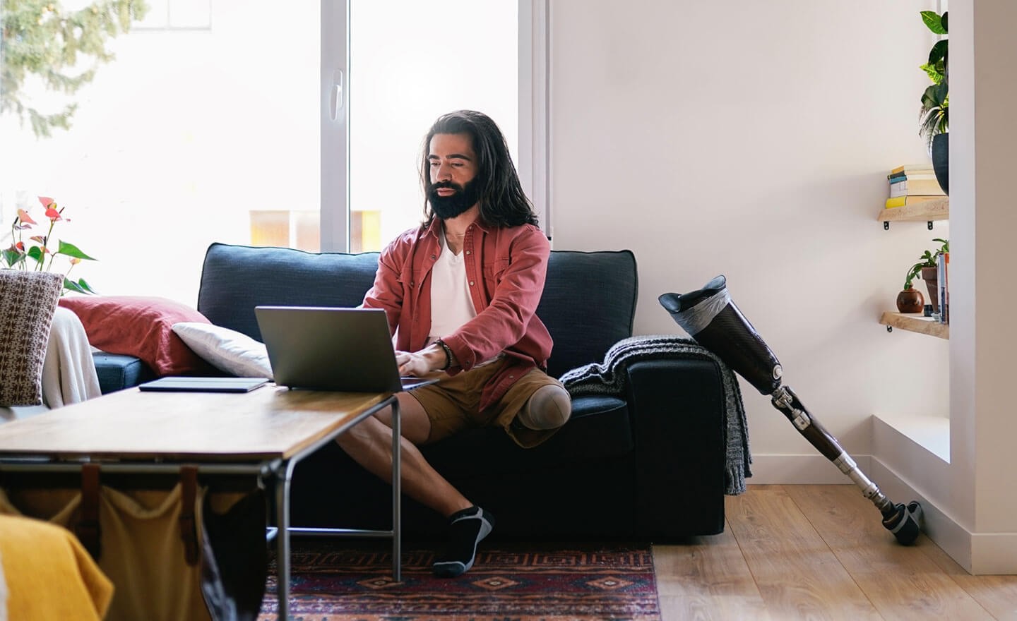 Disabled man working from home using laptop