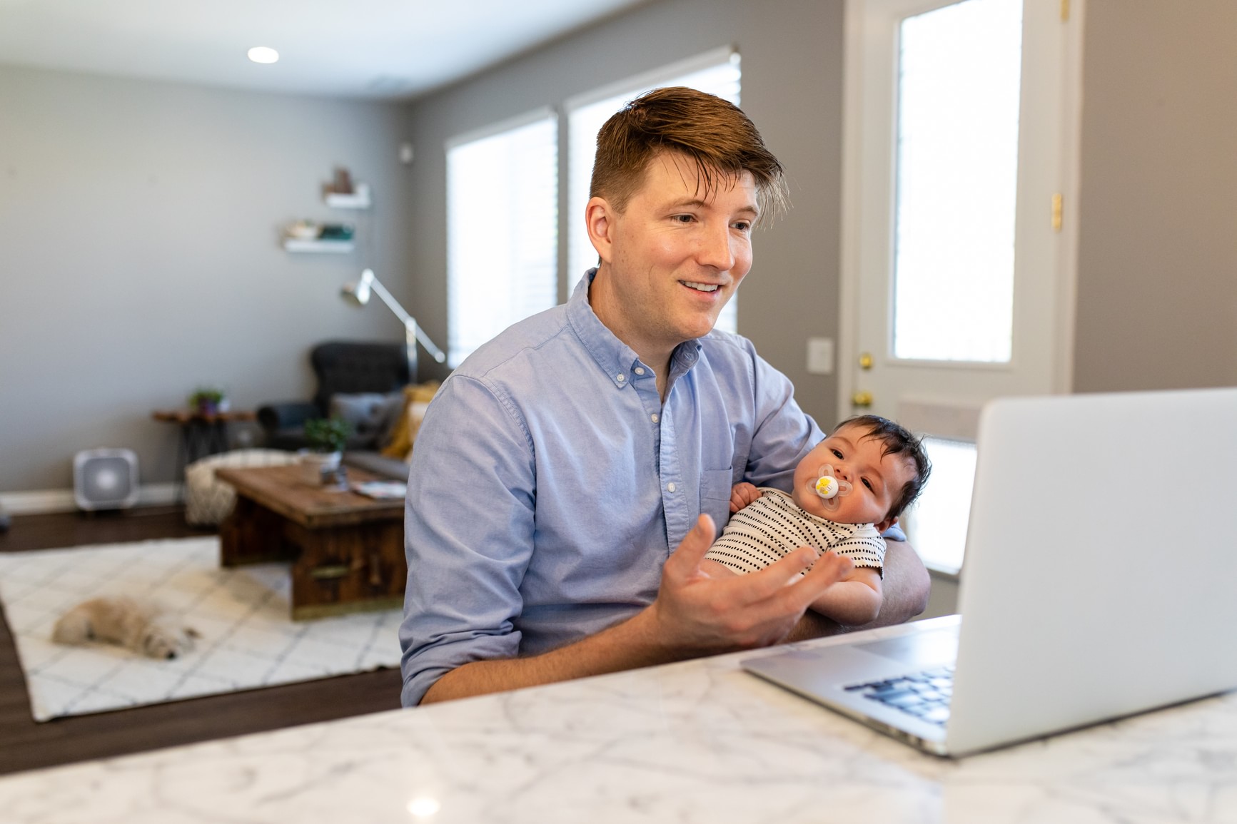 Father holding baby while on Zoom