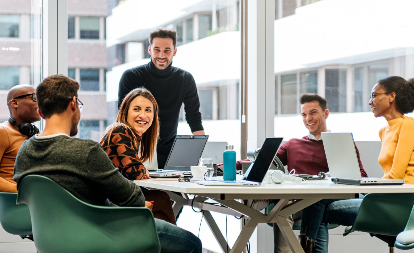 Group of coworkers around a conference table in a corporate office