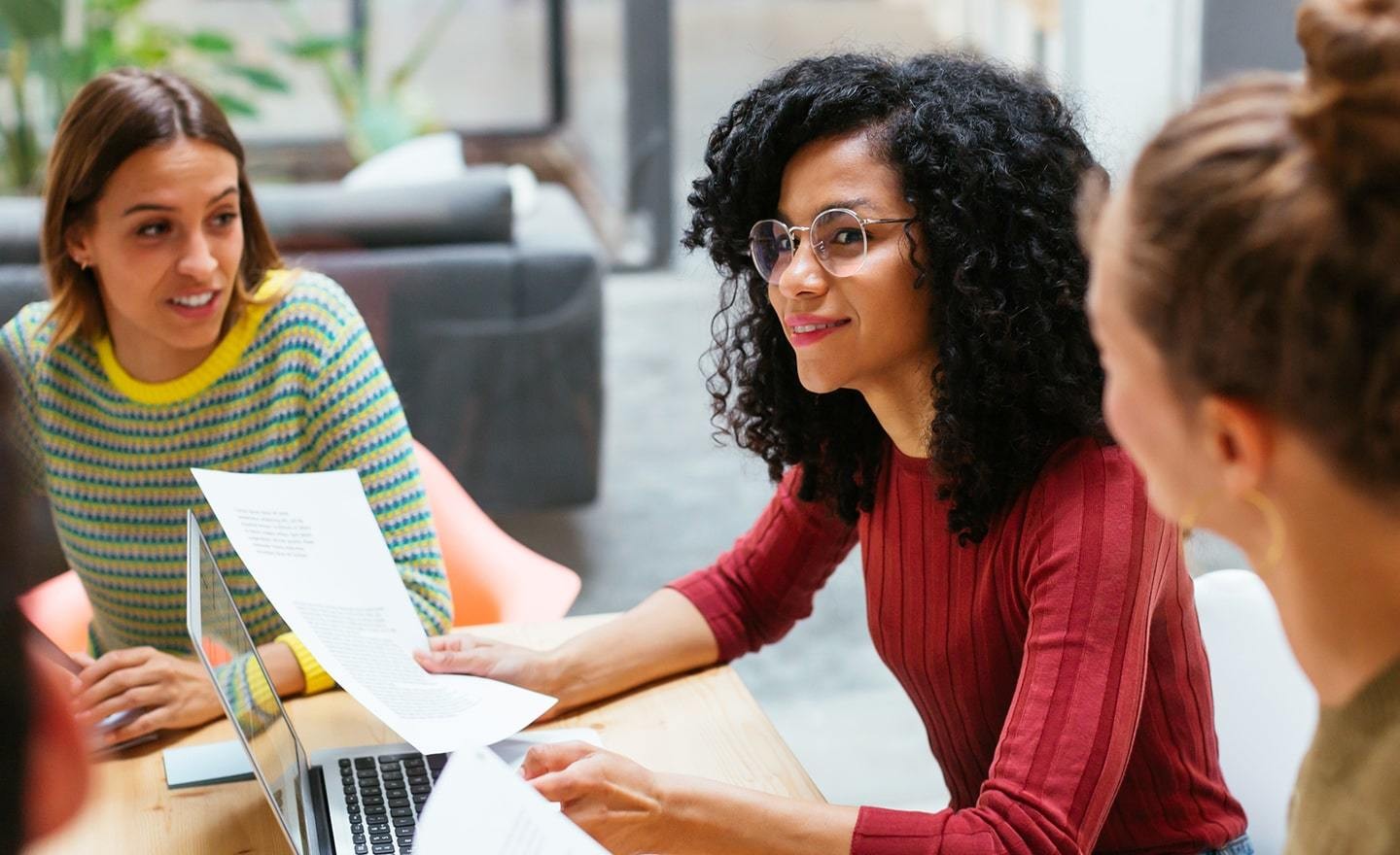 Group of coworkers around a table in an open office