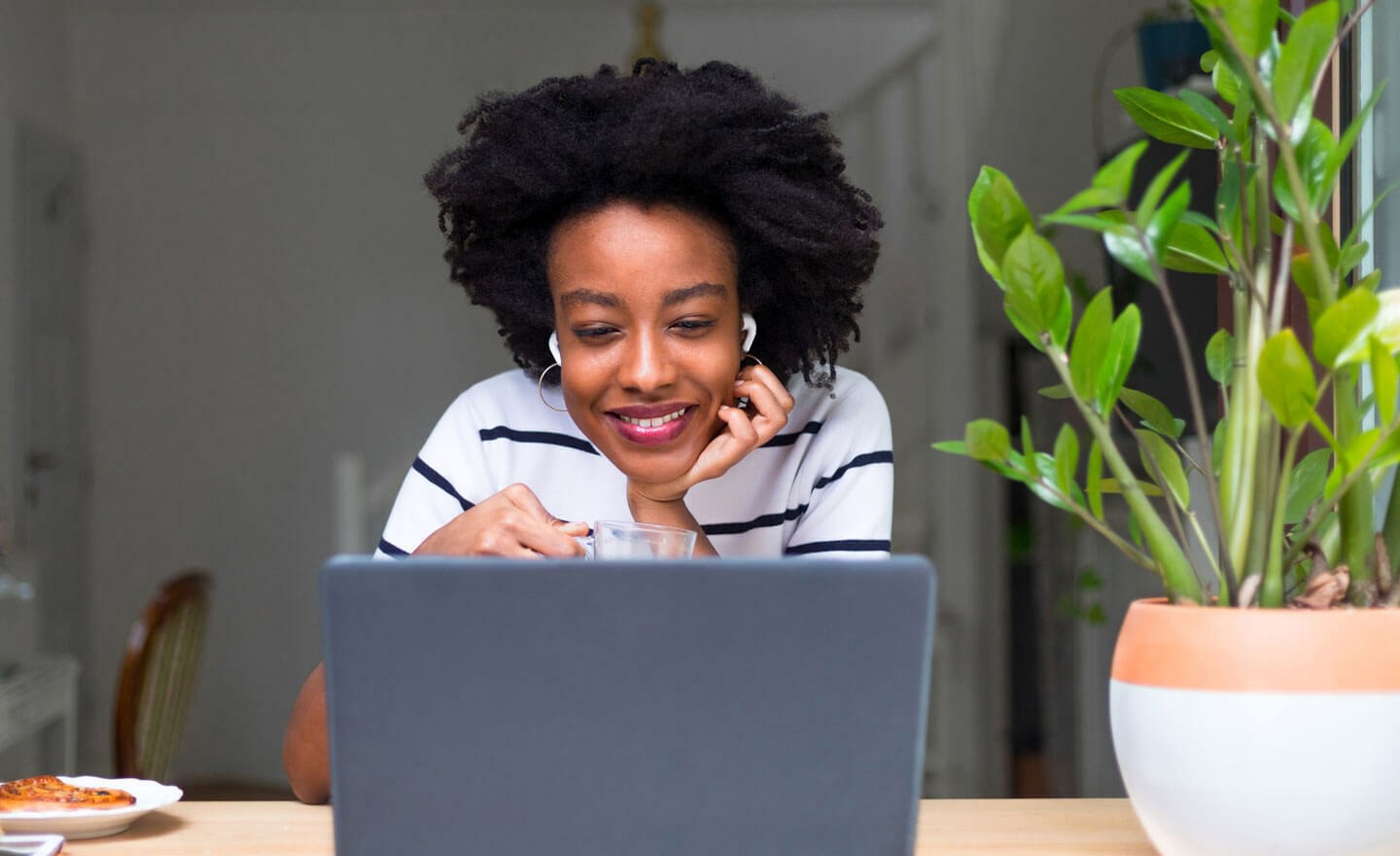 Happy person working on laptop with headphones