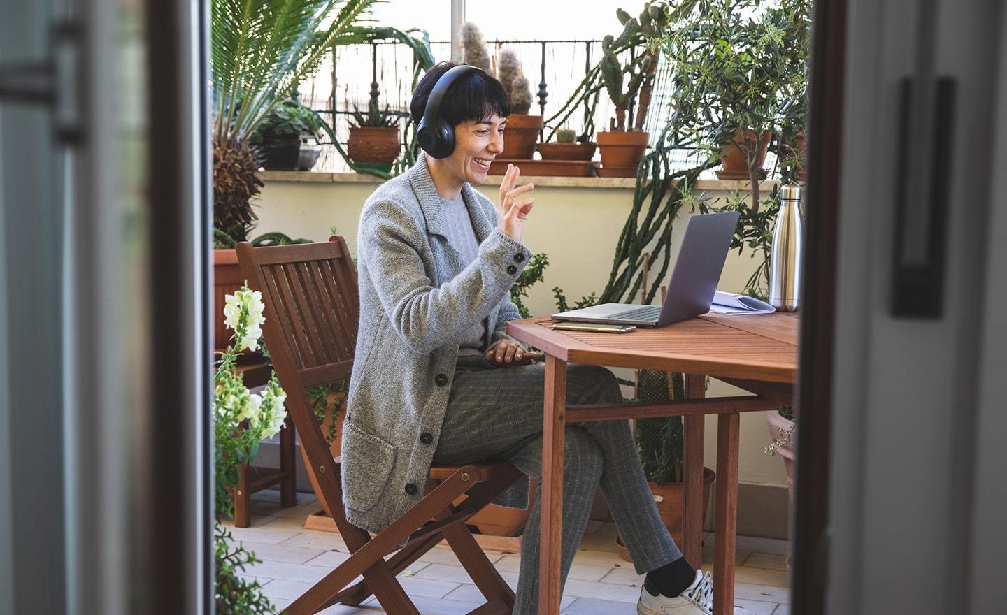 Happy woman waving on video call