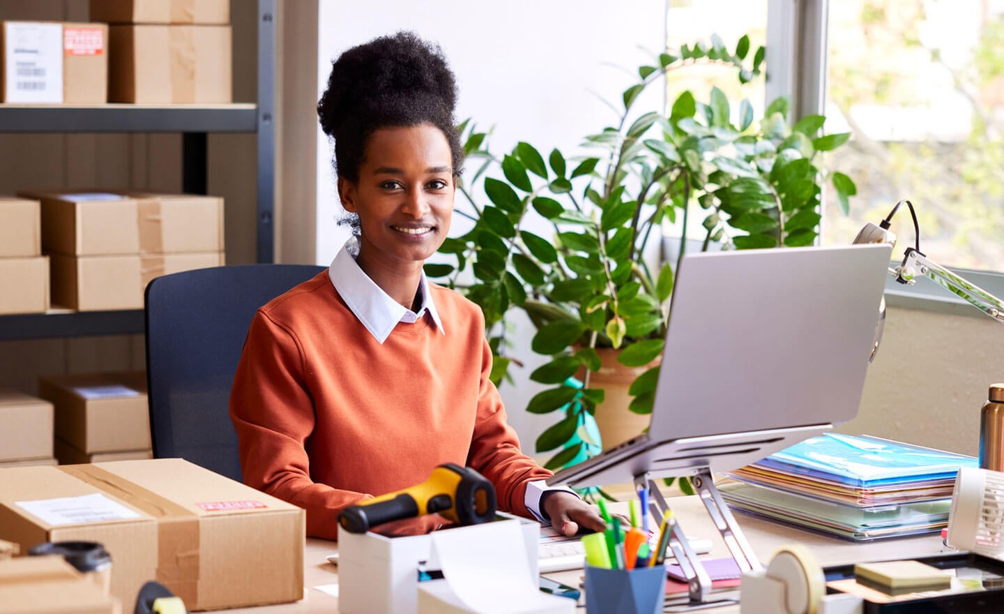 Happy worker at desk in startup office