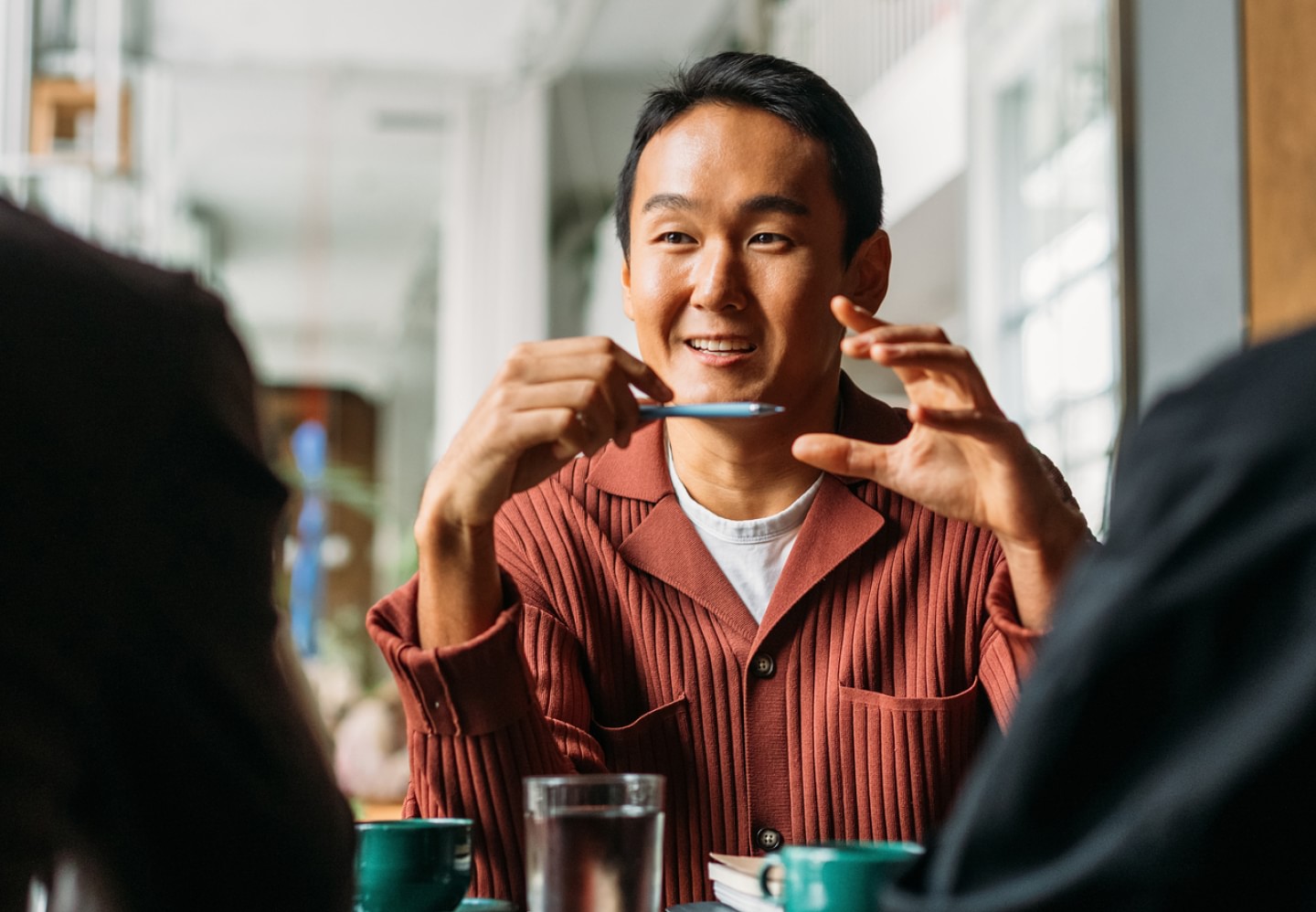 Male coworker talking to coworkers in office setting