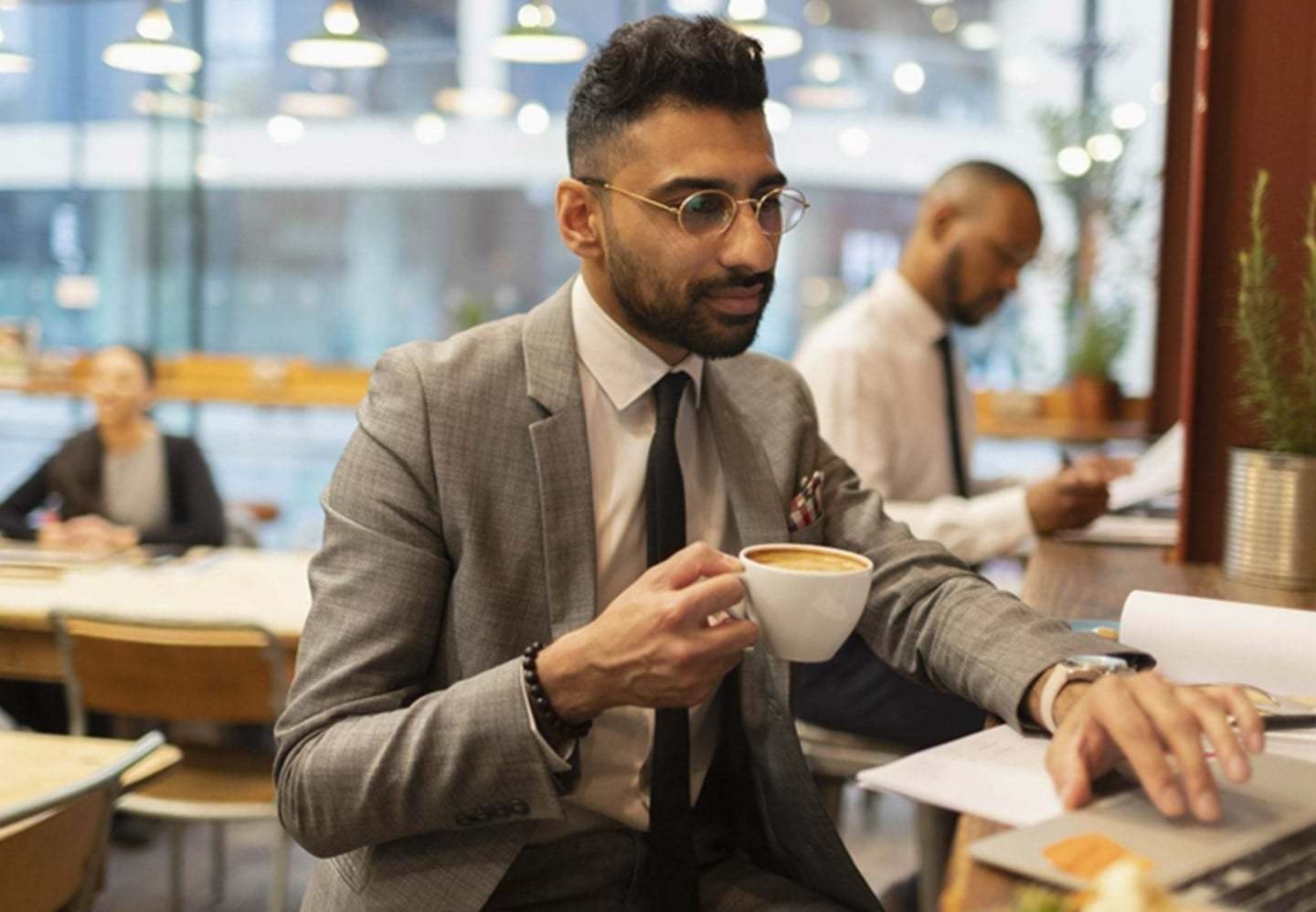 Man in a suit drinking coffee