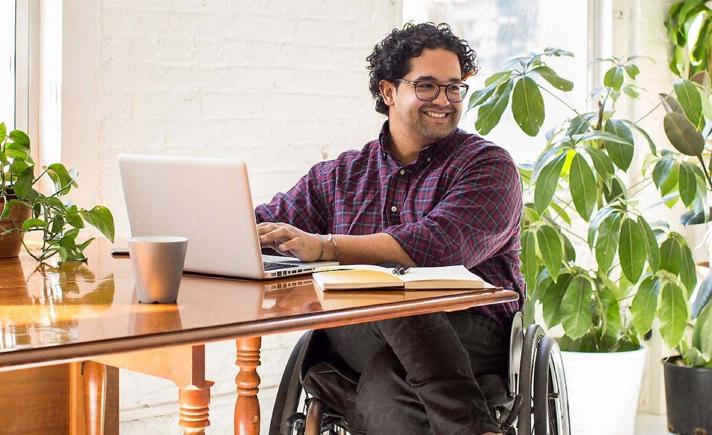 Man in wheelchair at table looking right