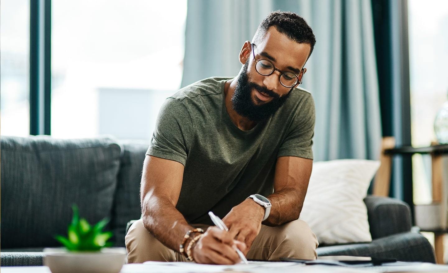 Man working from home writing notes