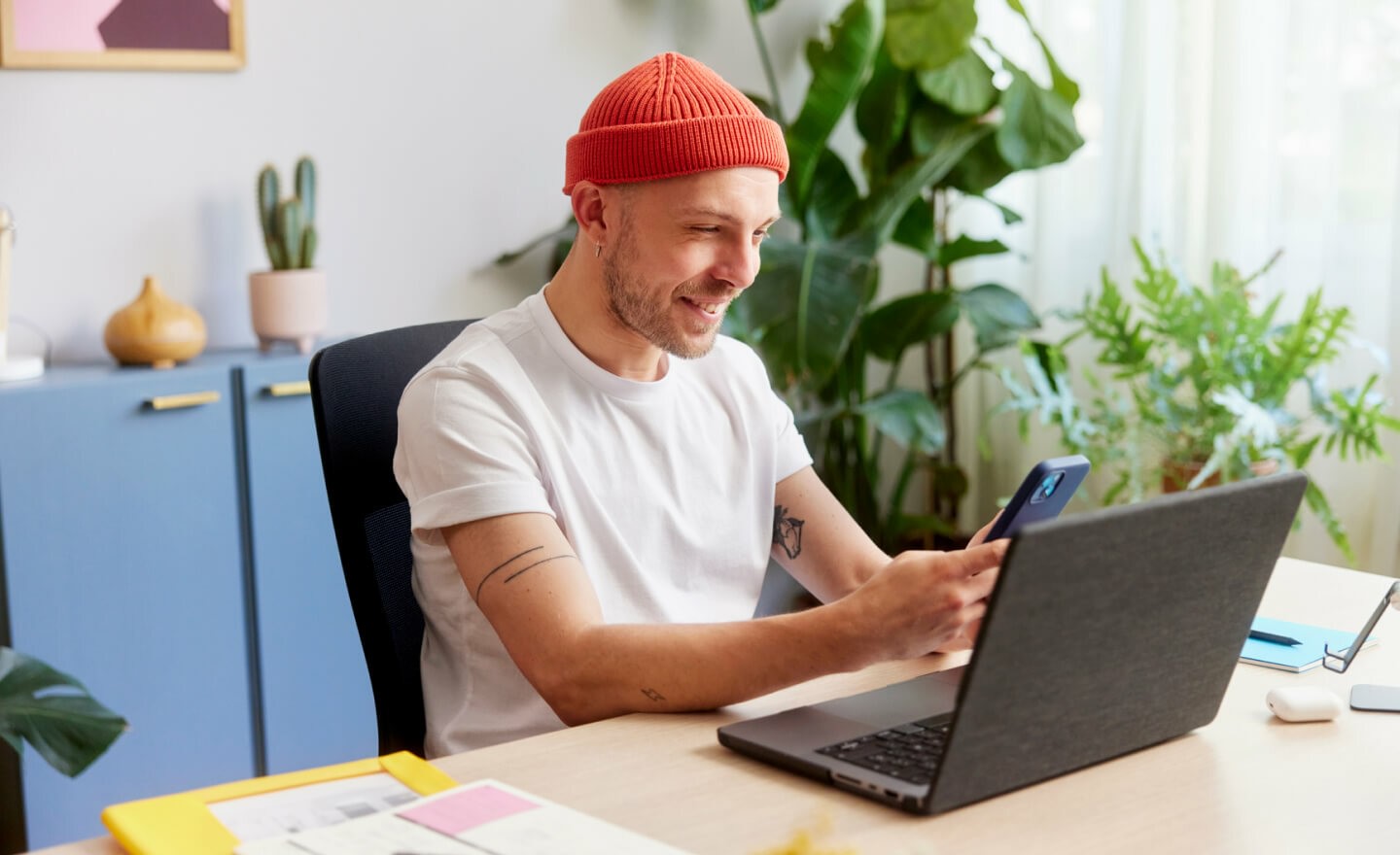 Person with beanie checking phone 720x440