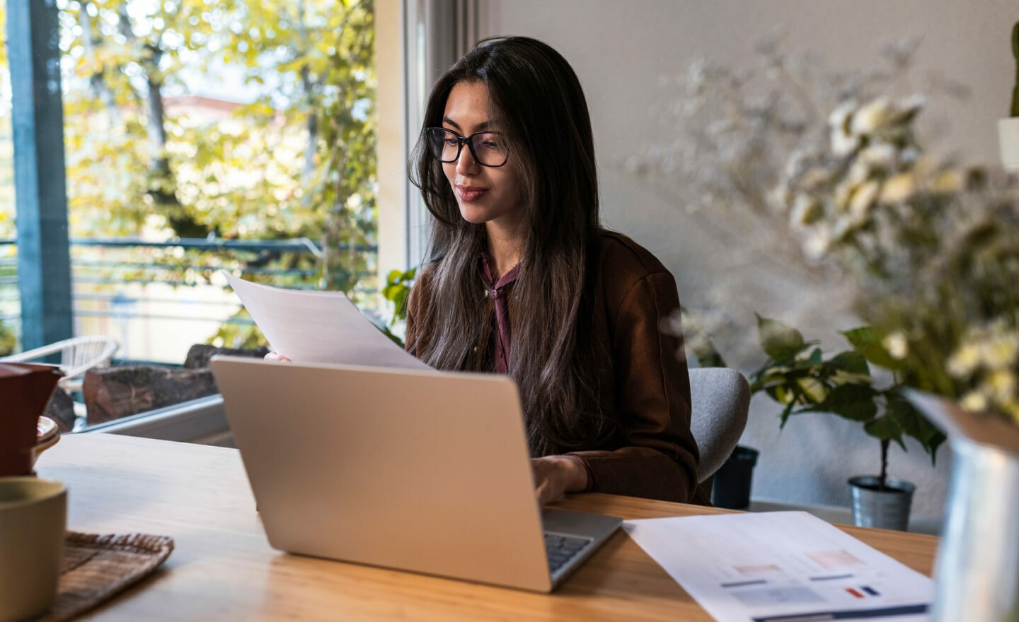 Person with glasses analysing at computer 720x440