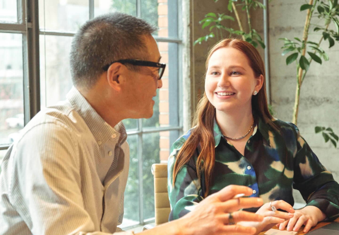 Photo of female and male coworkers talking in office 2