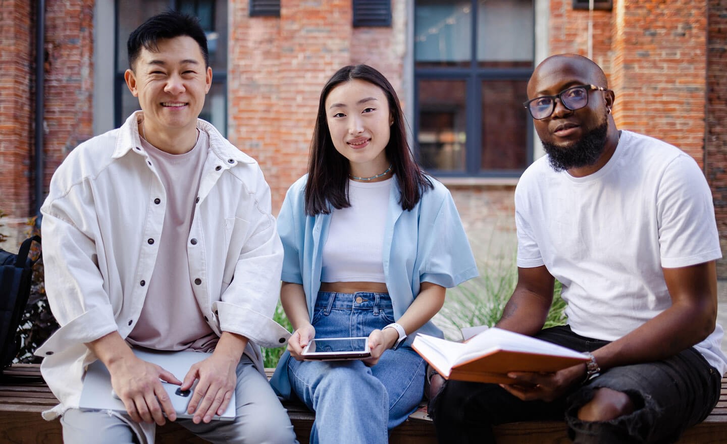 Portrait of three happy diverse coworkers