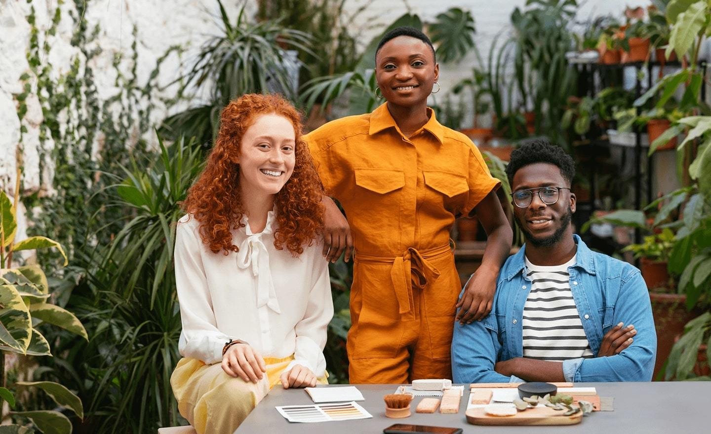 Three diverse people posing for camera