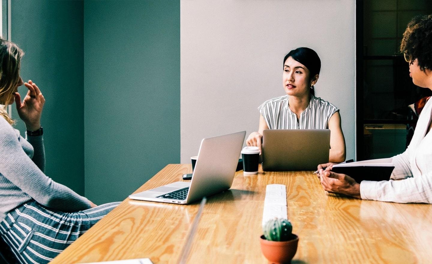 Three women in a conference room