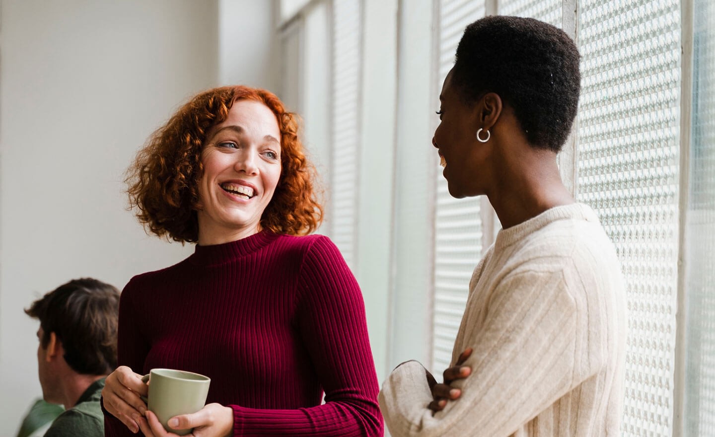 Two coworkers catching up over coffee