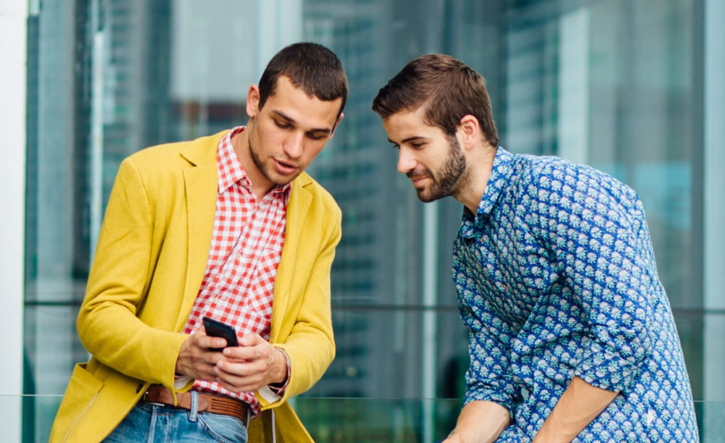 Two coworkers reviewing candidates on phone