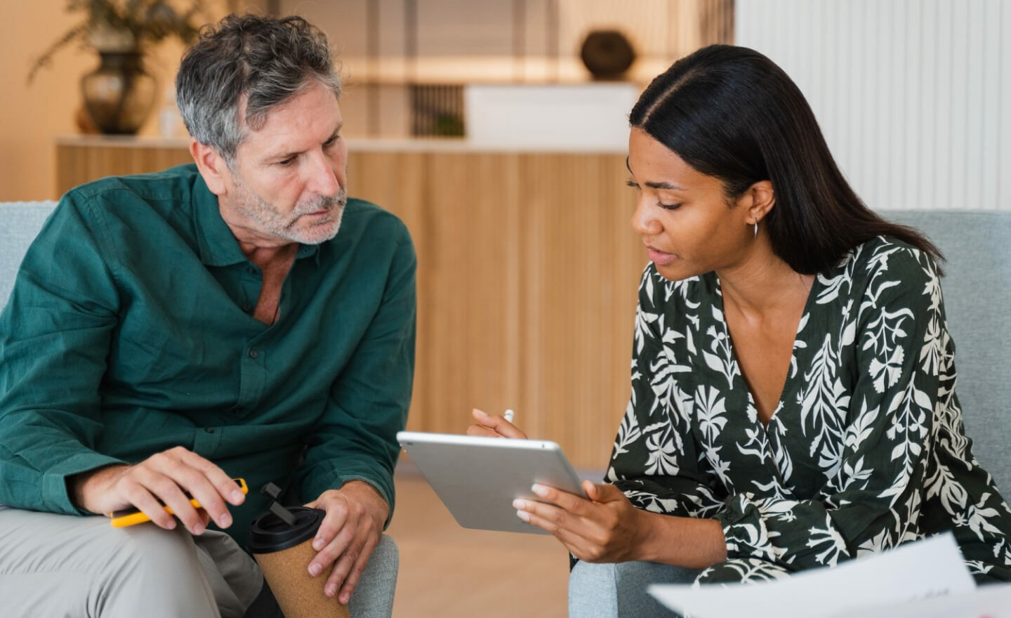 Two coworkers reviewing data on tablet