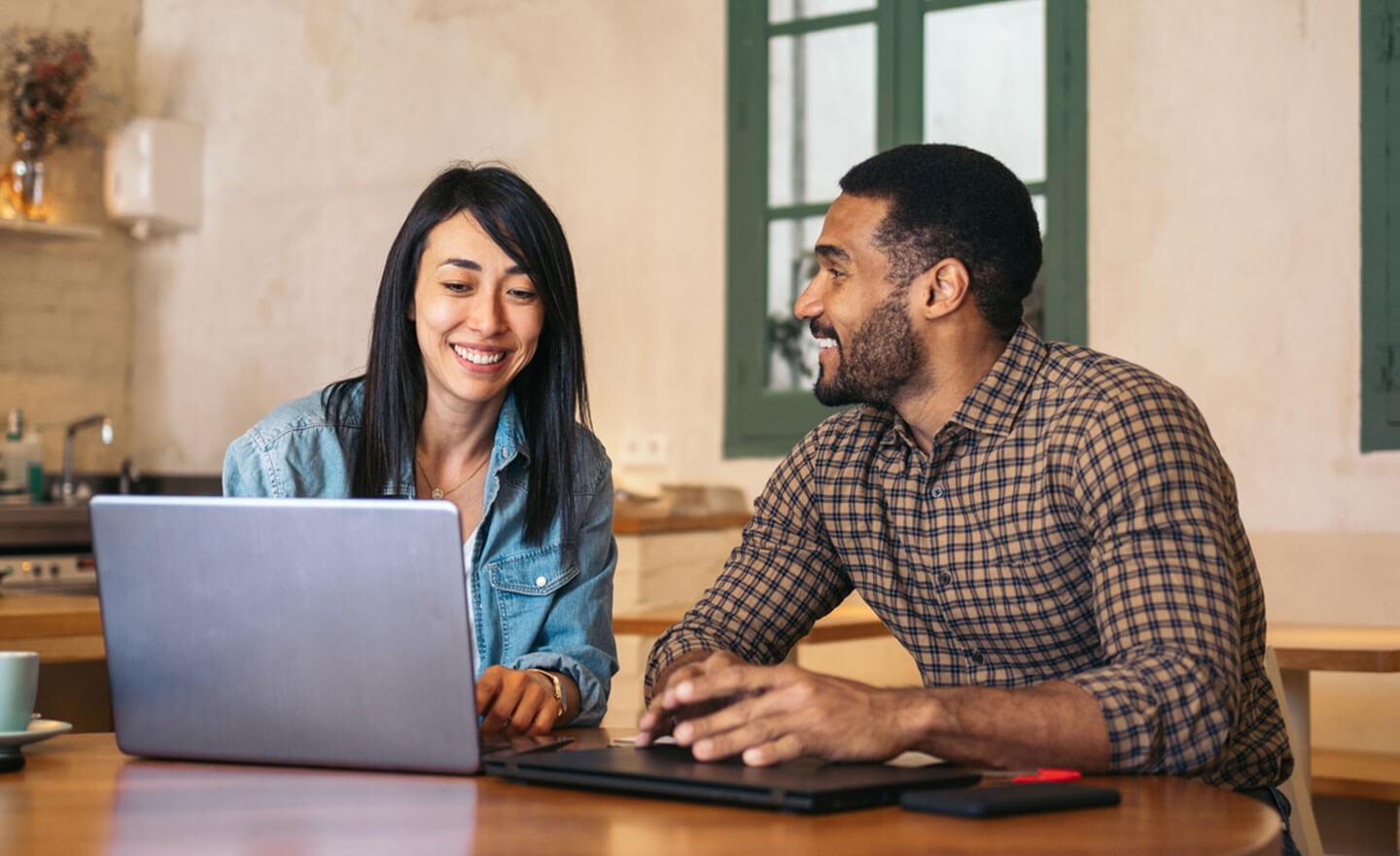 Two coworkers working in coffee shop