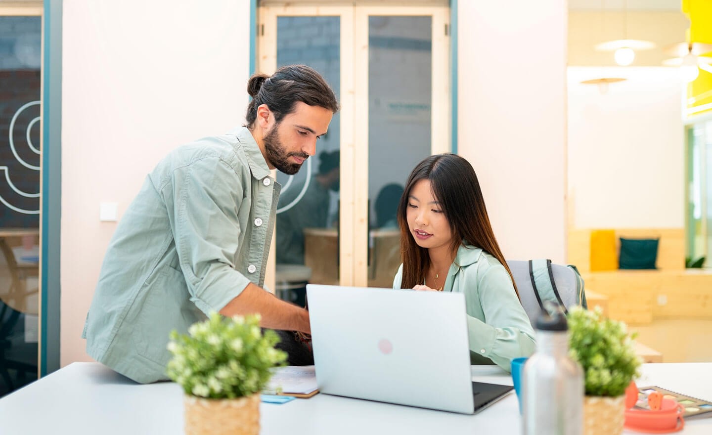 Two coworkers working in office