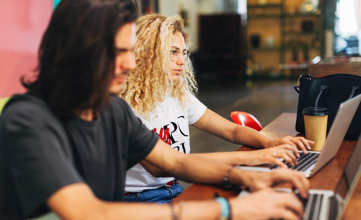 Two people working on their laptops