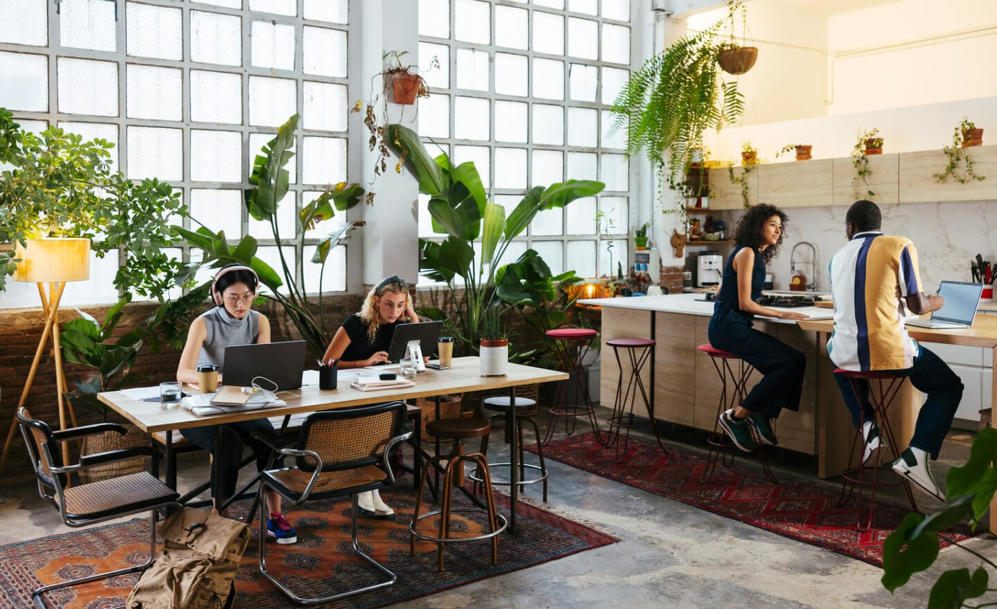 Wide shot of an office with many people working