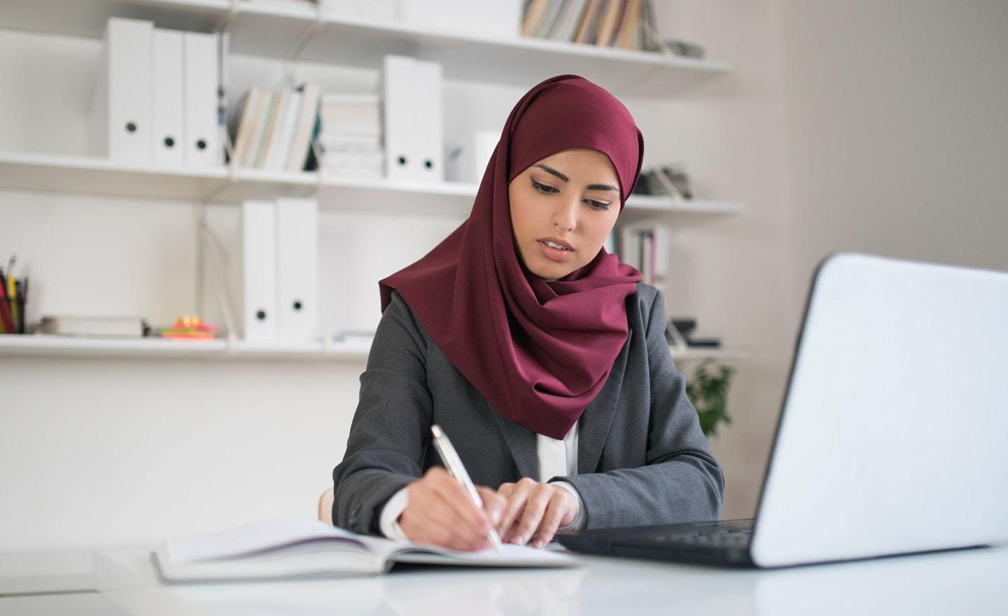 Woman in a hijab at her desk