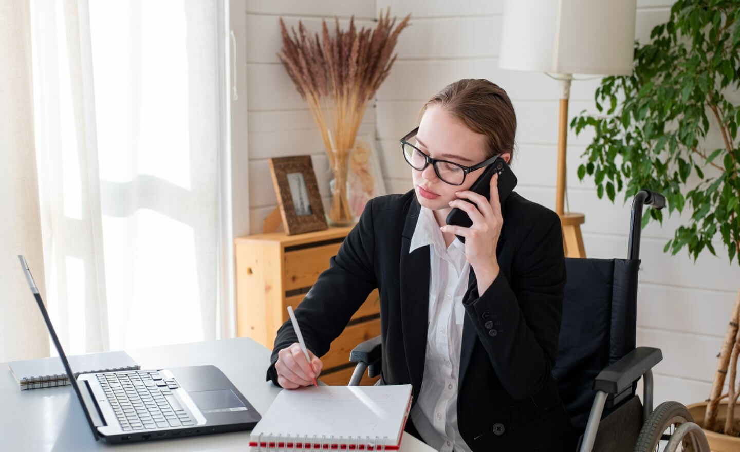 Woman in wheelchair working from home