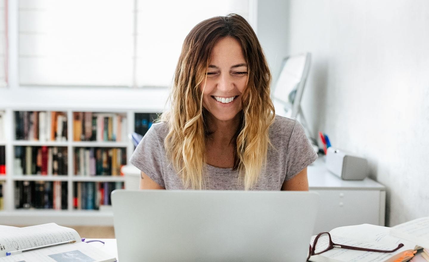 Woman smiling at laptop