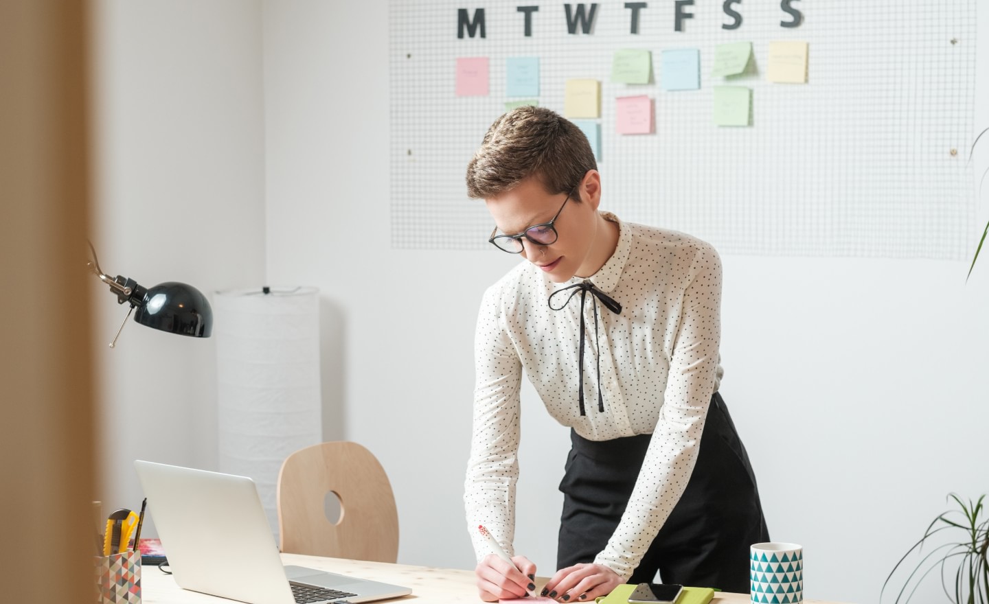 Woman writing at desk