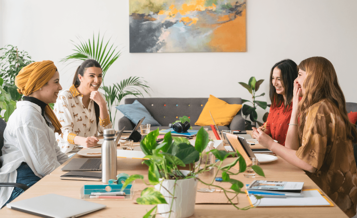 Group of women laughing during team meeting