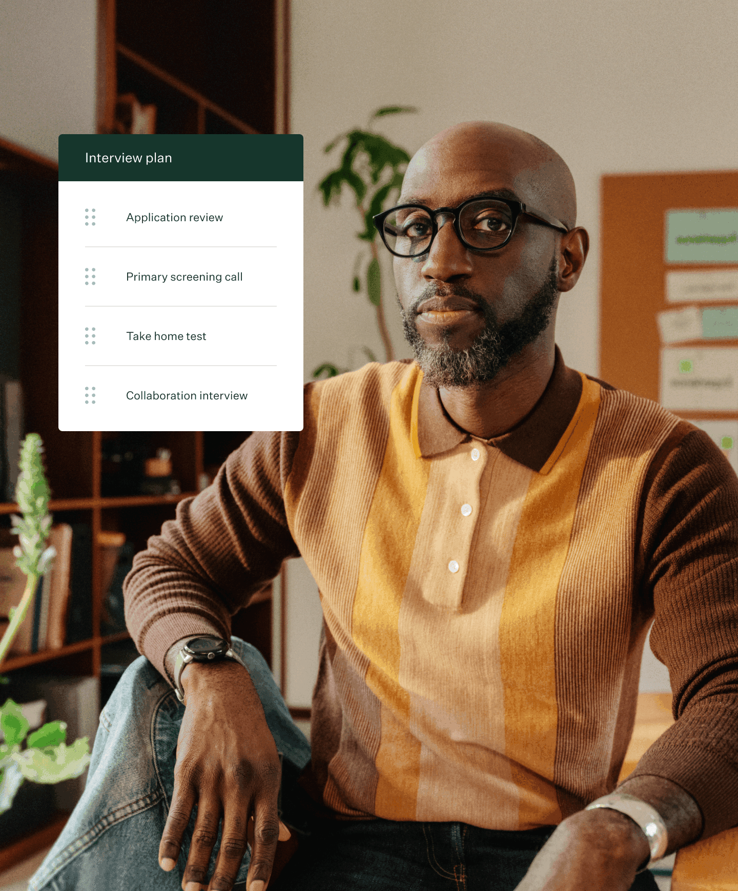 Man in office posing wearing warm toned collared shirt and greenhouse interview plan ui