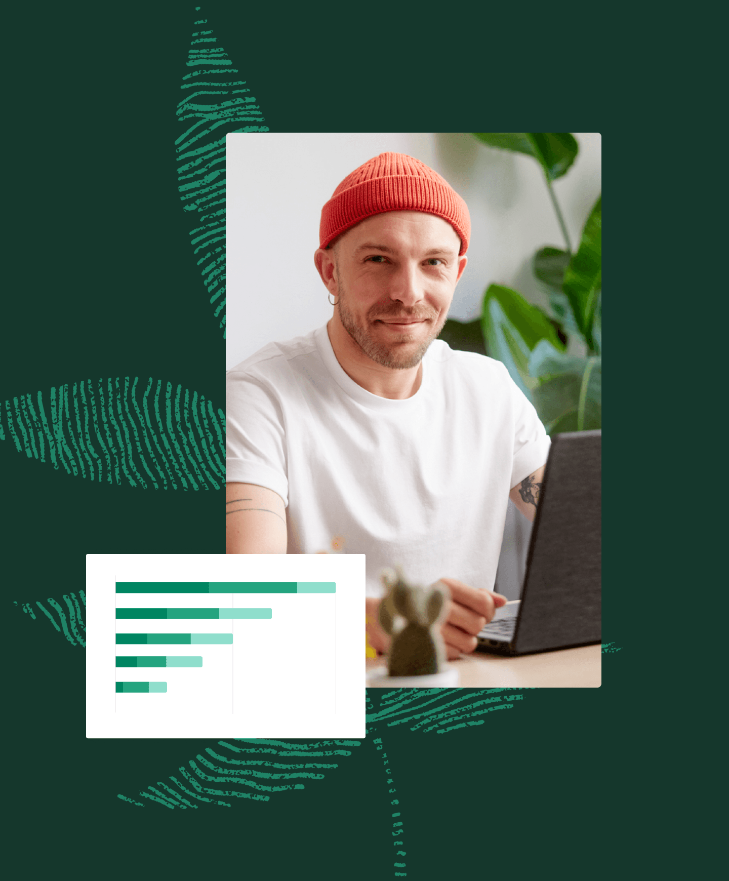 Man smiling sitting behind laptop next to graph ui