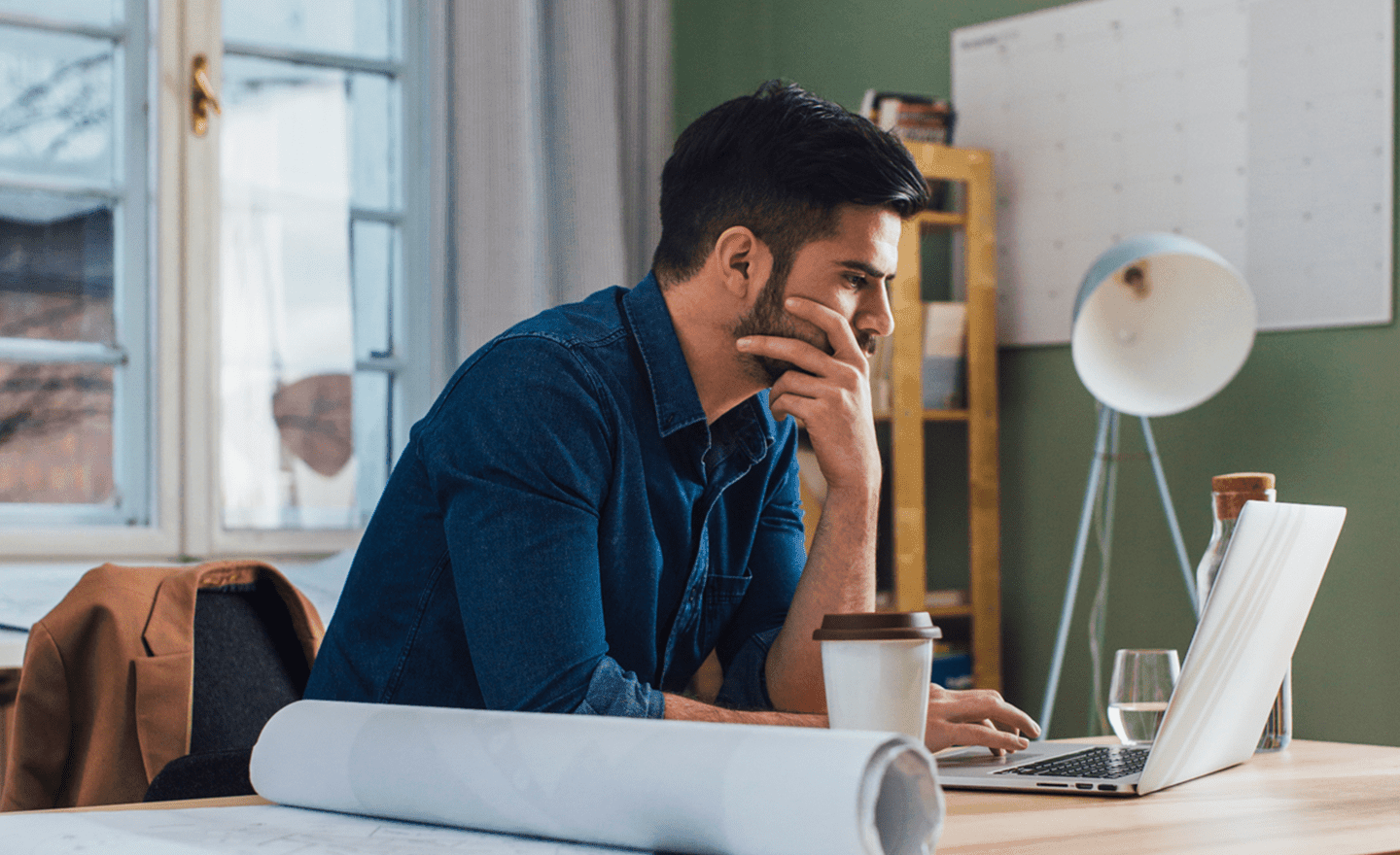 Man working on laptop in home office