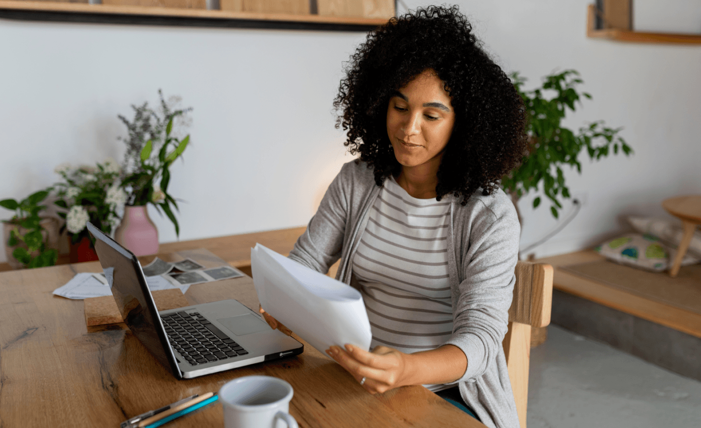 Woman reviewing document while sitting down smiling